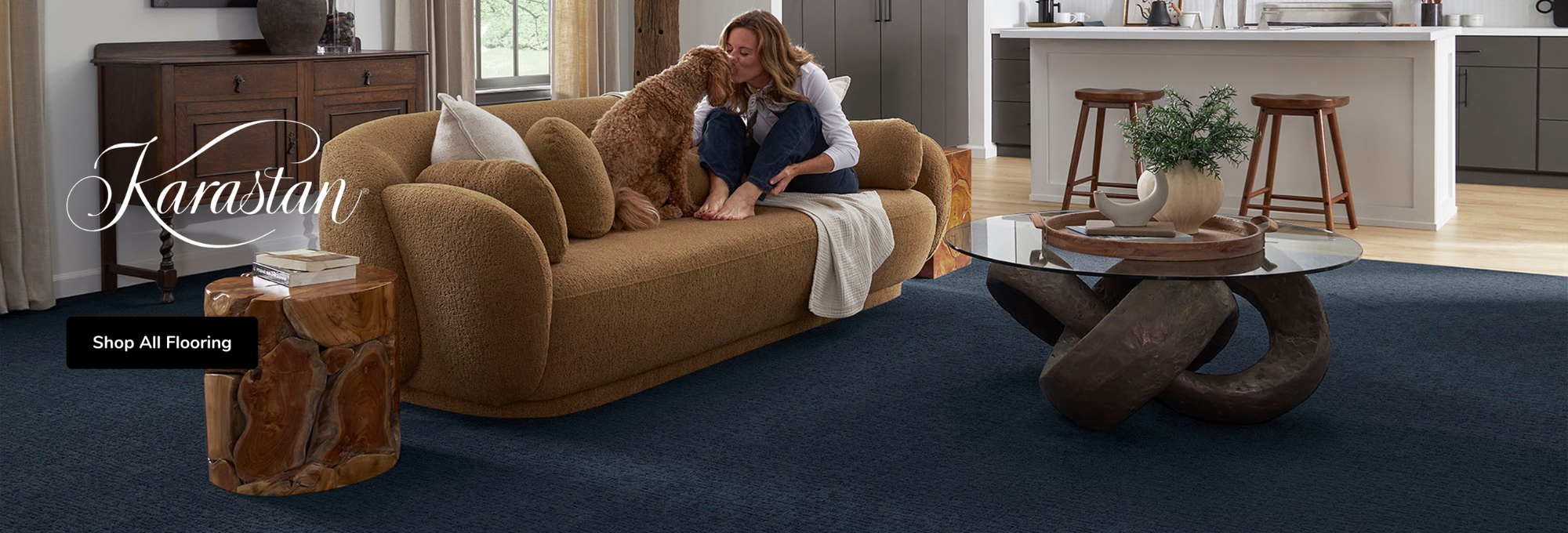 Karastan Carpet Promotion featuring a living room with grey carpet flooring and a mother and child reading on the sofa