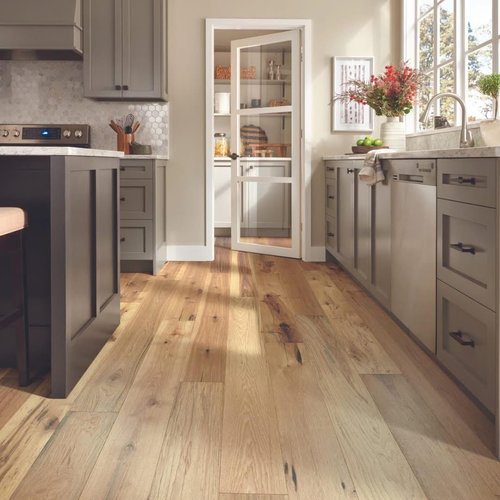 Bright kitchen with durable wood floors by Monarch Floor & Home
