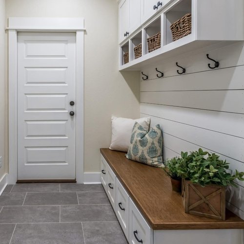 Stylish laundry room with grey tile flooring in Edmonton